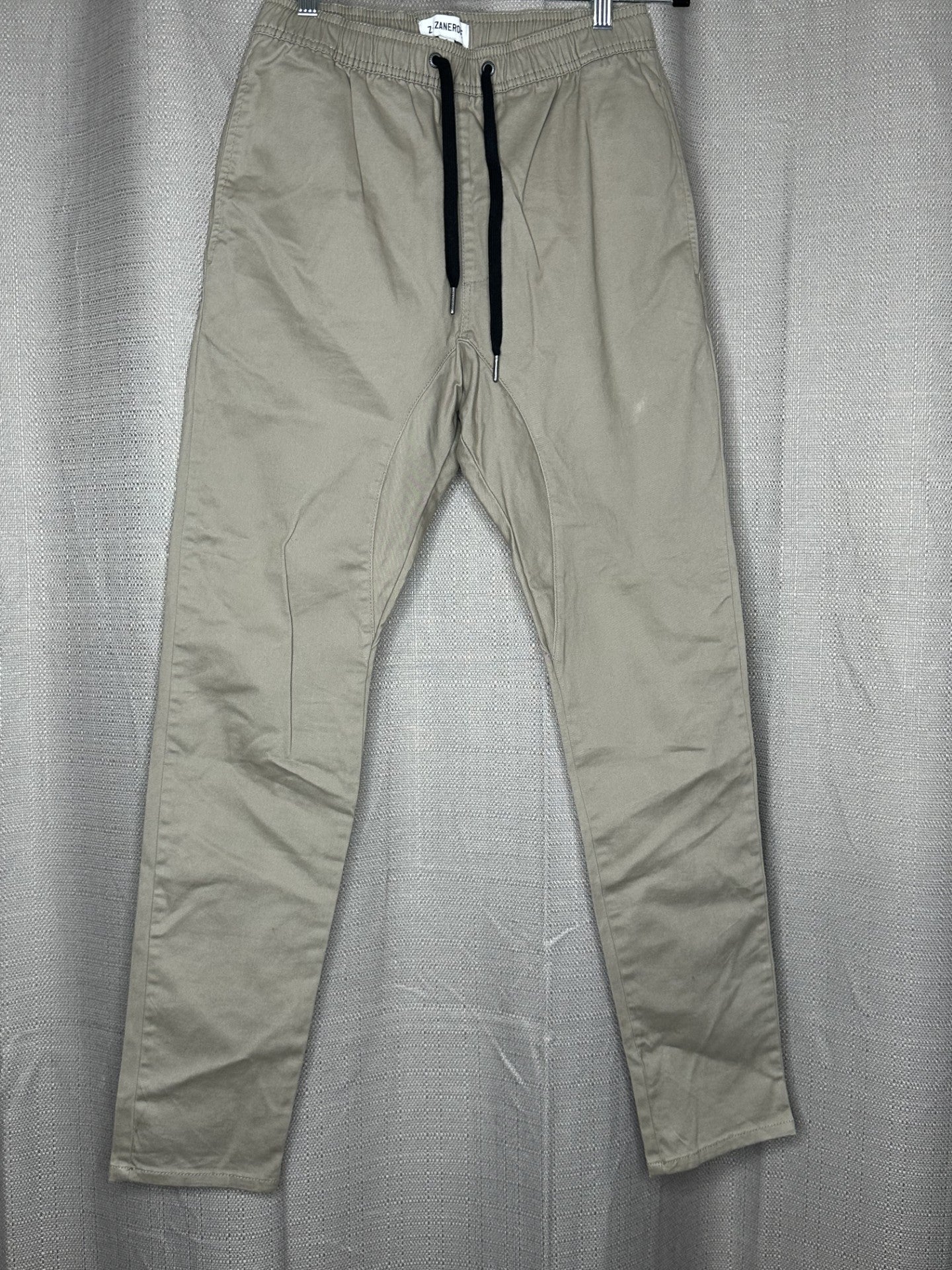 Beige pants with black drawstring waist