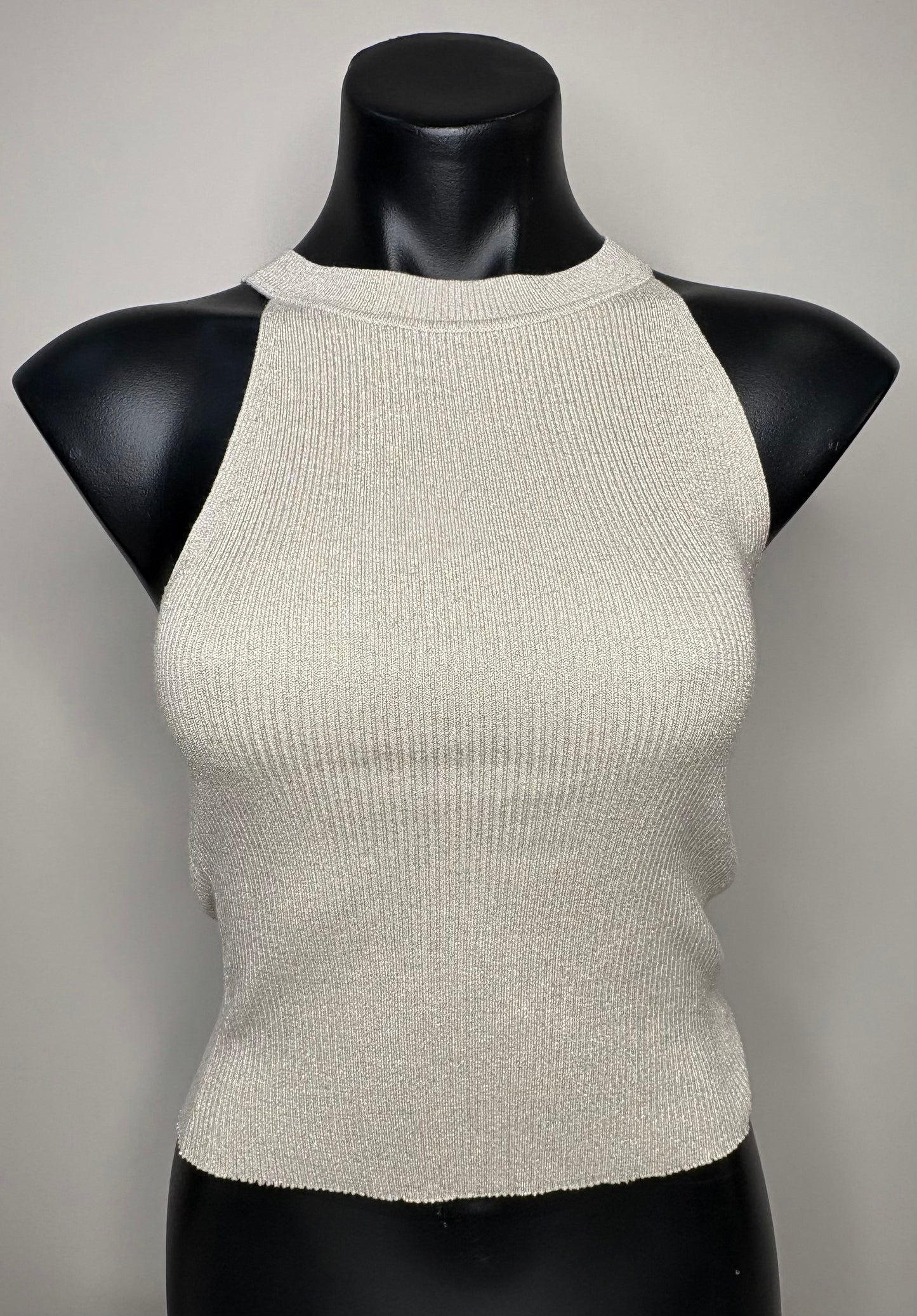 Beige ribbed knit top on a black mannequin against a gray background