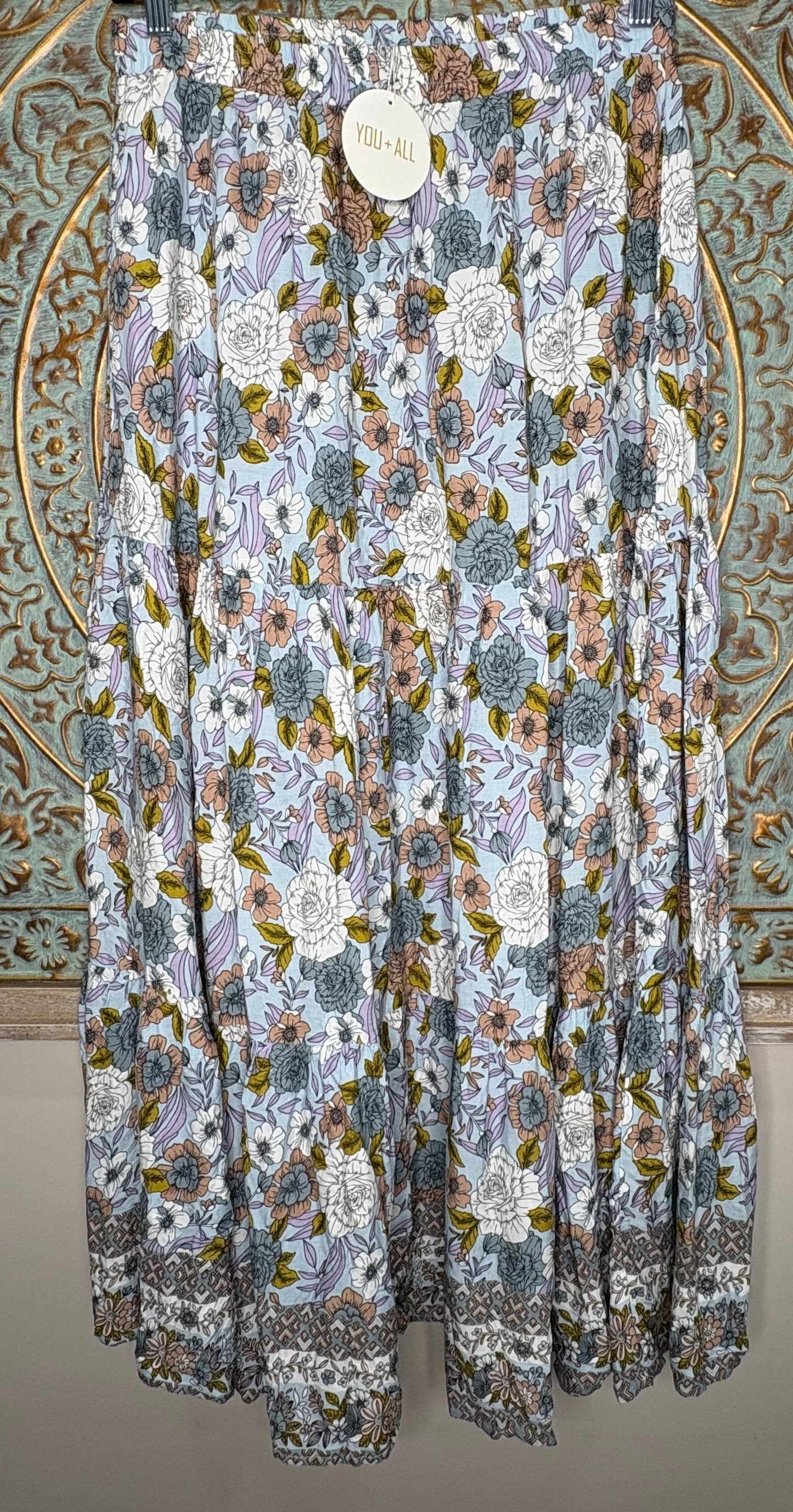 Floral patterned fabric draped over a decorative background