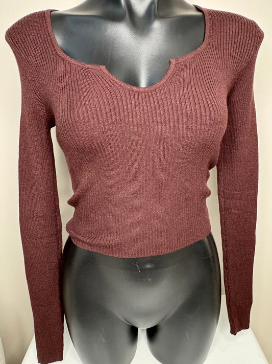 Maroon sweater on a mannequin against a plain background