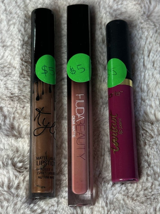 Three lip gloss tubes 