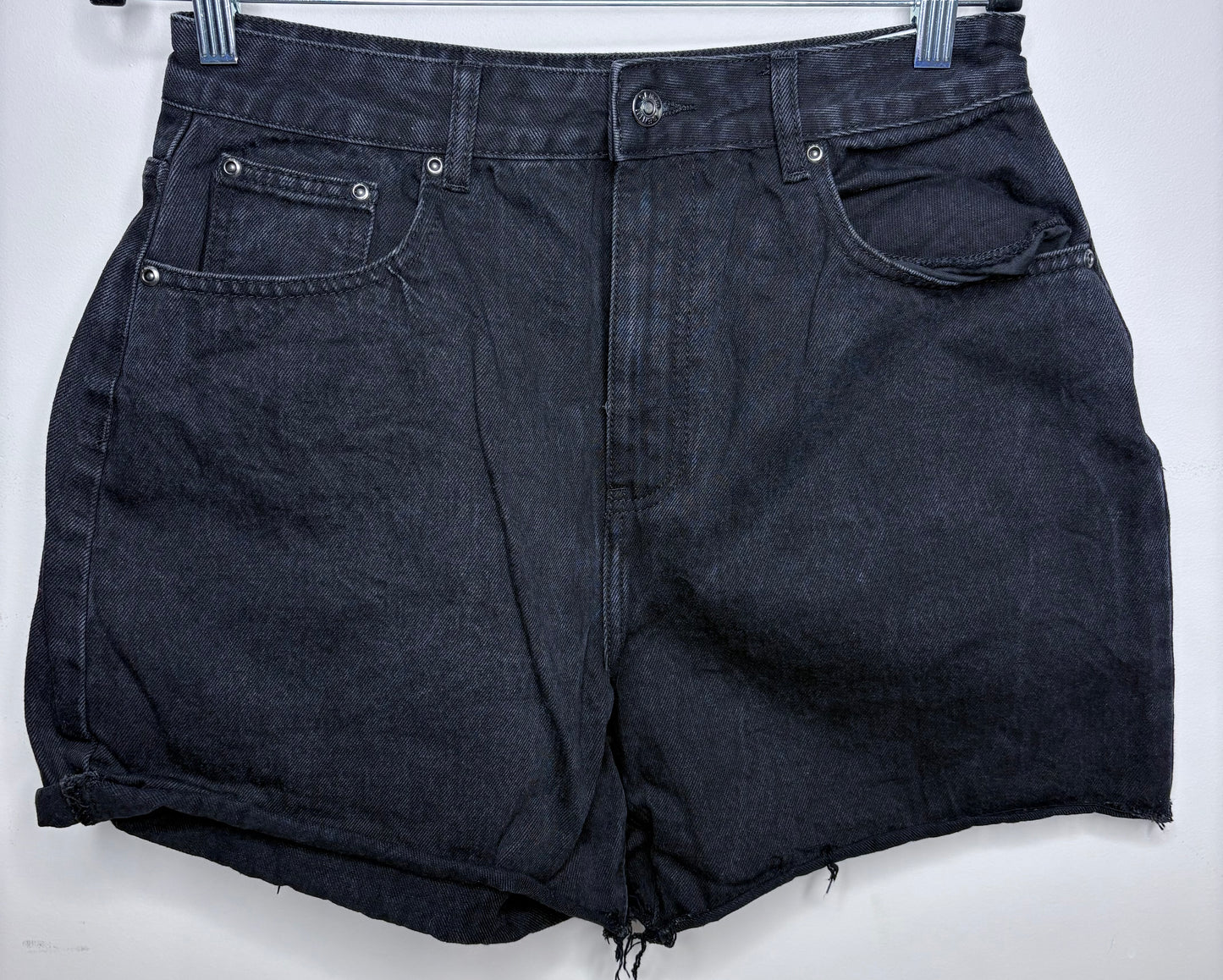 Black denim shorts on a white background