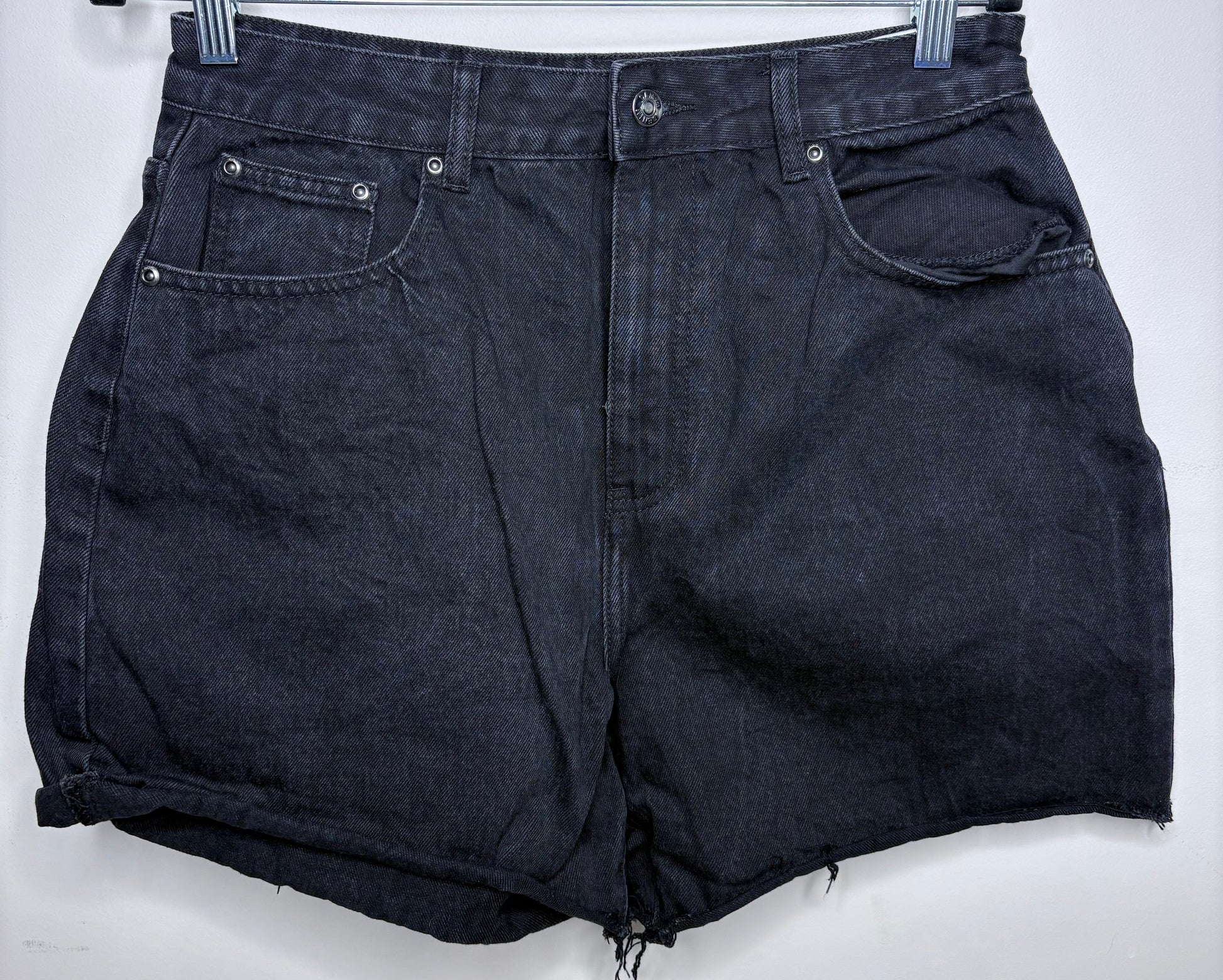 Black denim shorts on a white background