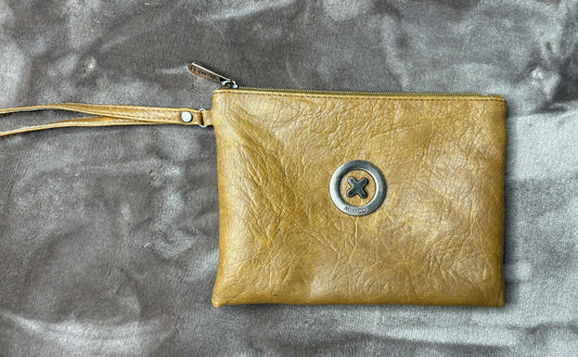 Gold leather clutch with a button on a textured gray background
