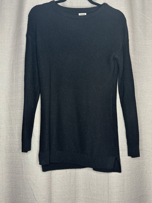 Black textured sweater on a light gray background