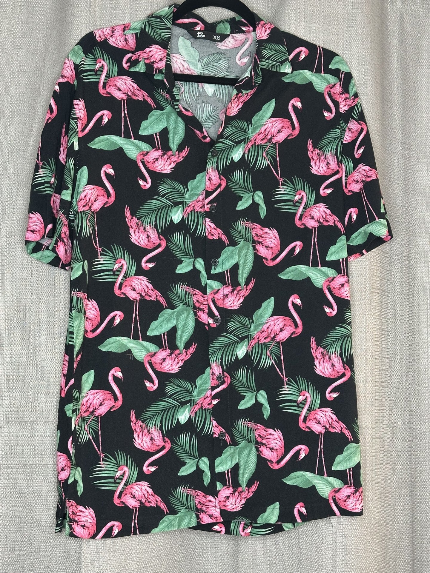 Black shirt with pink flamingo and green leaf pattern 