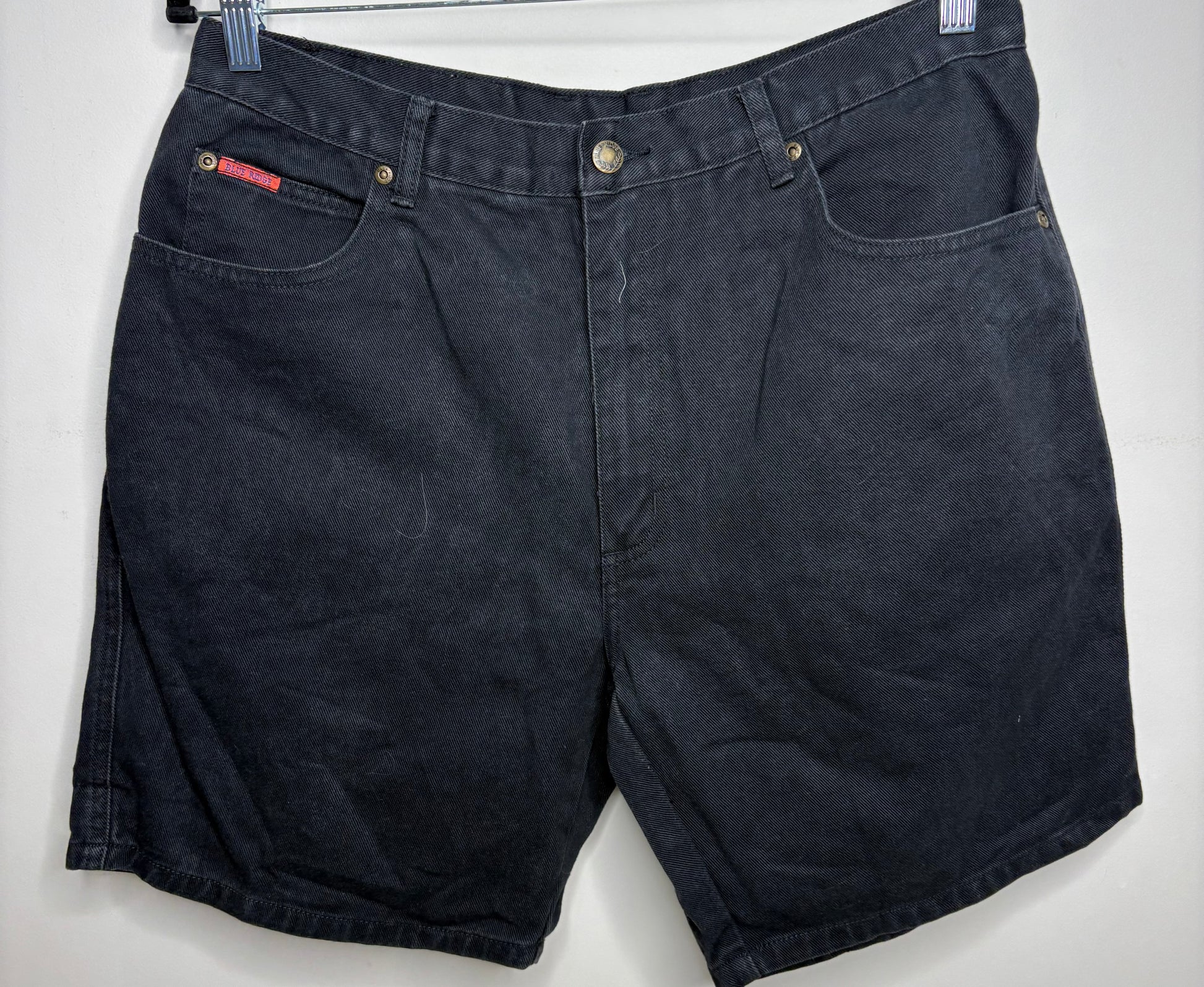 Black denim shorts on a white background