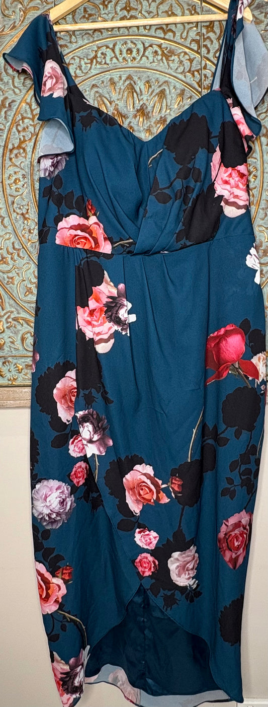 Emerald green floral dress on a decorative backdrop.