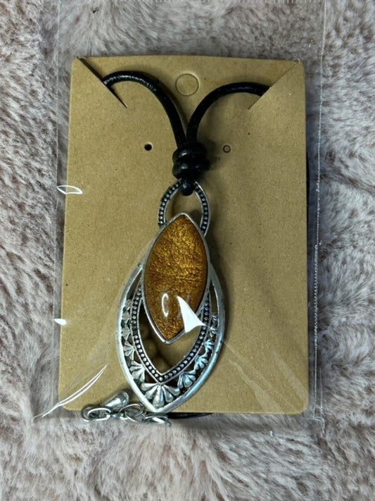 Copper and silver Pendant On a leather necklace 