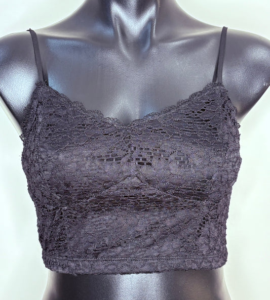 Black lace bralette on a mannequin against a white background
