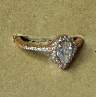 Gold ring with a tear drop design