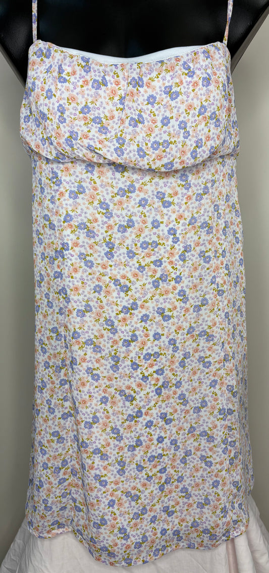 Floral-patterned apron on a mannequin against a neutral background