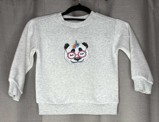 Gray sweatshirt with a panda design on a hanger against a gray background
