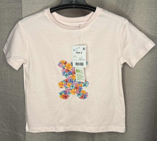 White t-shirt with colorful floral design and size tag on a gray background
