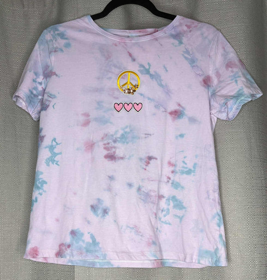 Tie-dye t-shirt with peace symbol and hearts on a gray background