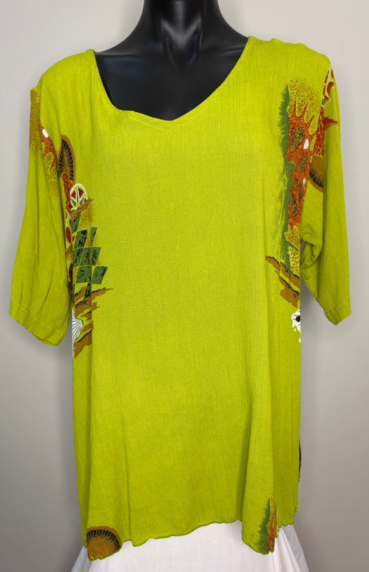 Green top with floral embroidery on a mannequin against a white background
