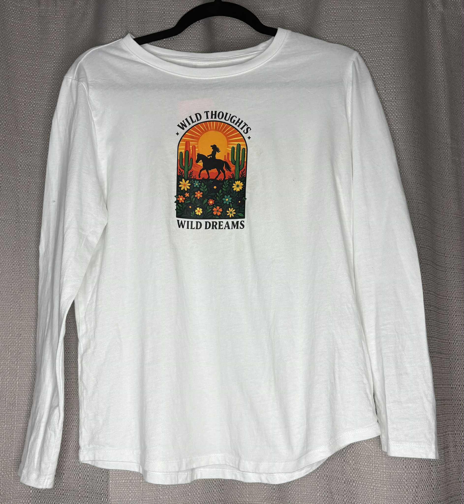 White long-sleeve shirt with a graphic design on a gray background