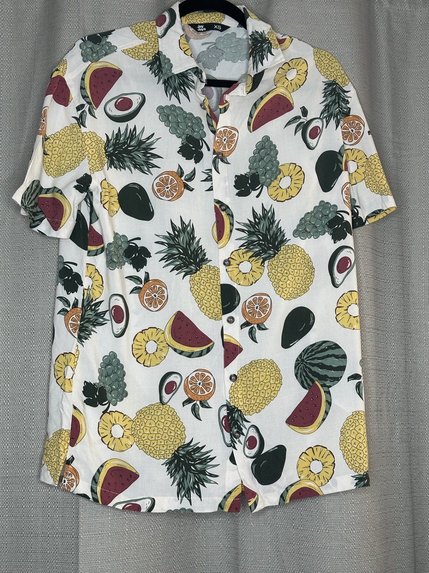 Hawaiian fruit pattern on an off white shirt