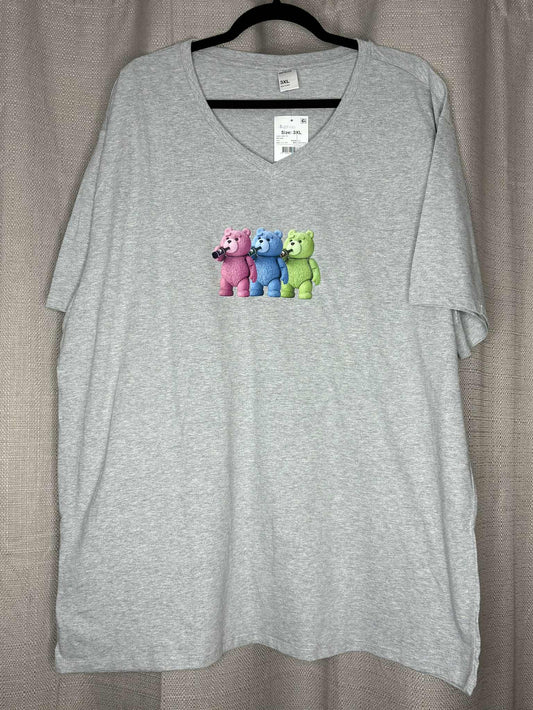 Gray t-shirt with colorful bear design on a hanger against a neutral background