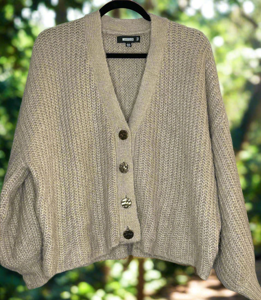 Beige cardigan on a hanger 