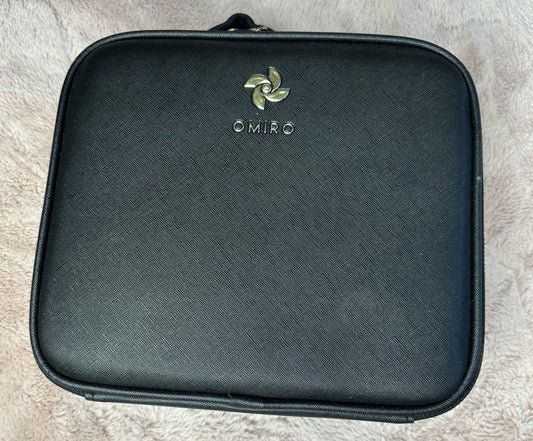 Black cosmetic bag with 'OMIRO' branding