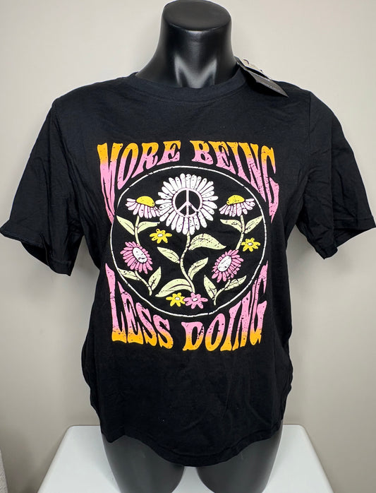 Black t-shirt with colorful graphic and text on a mannequin against a neutral background