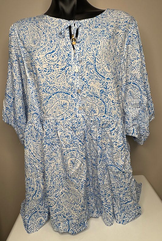 Blue and white patterned blouse on a mannequin against a beige background