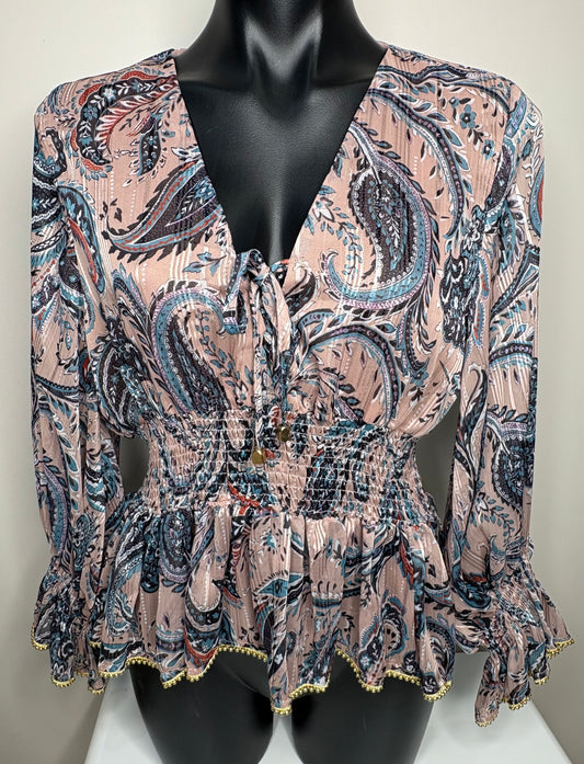 Patterned  Satin blouse with gold bead accent on cuffs and edging on a mannequin 