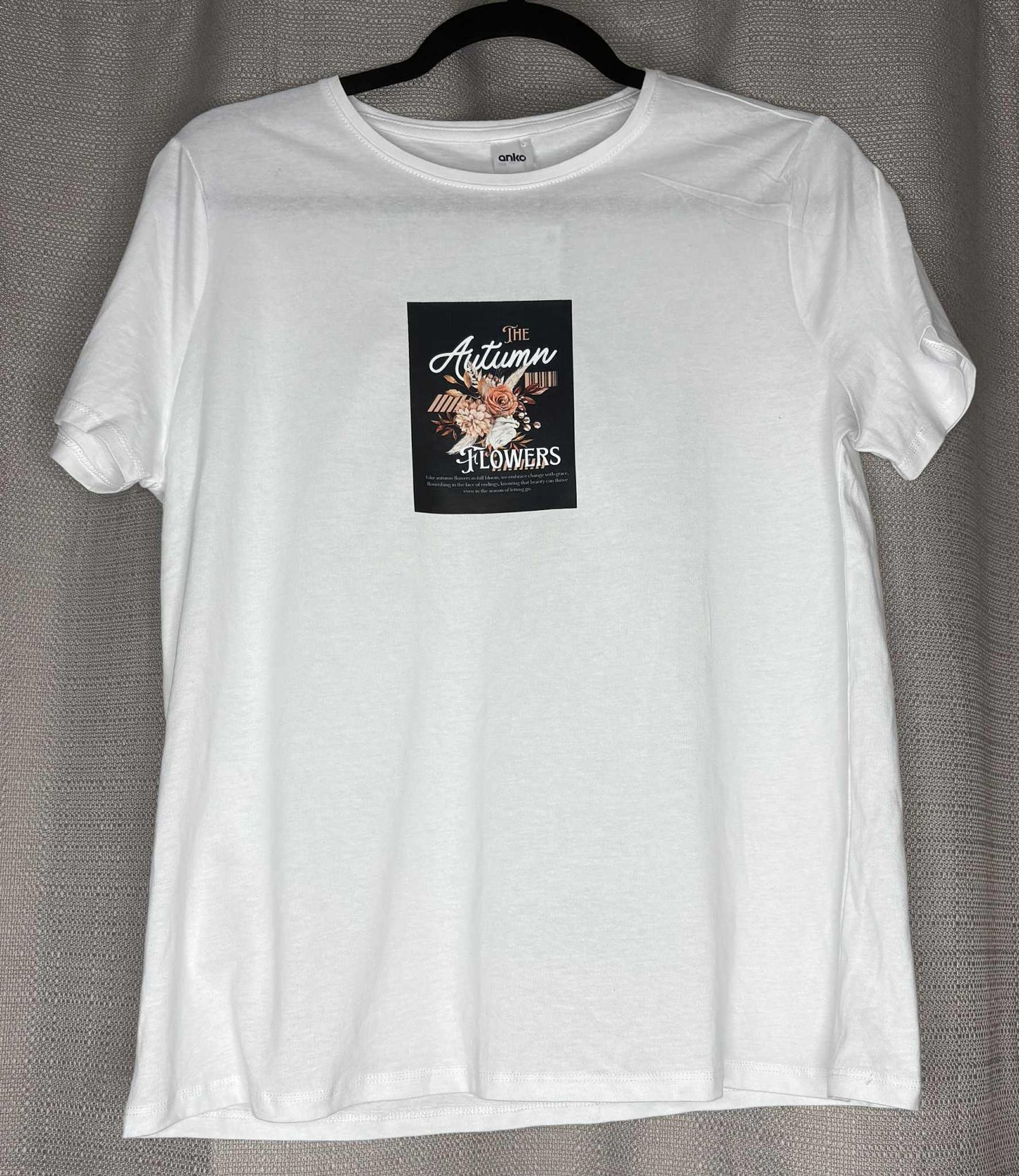 White t-shirt with a graphic design on a gray background