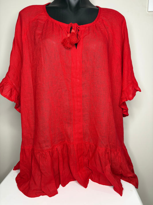 Red blouse with ruffled sleeves on a mannequin against a white background