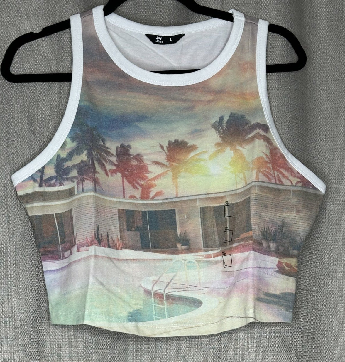 Tank top with a tropical design of a house and palm trees 