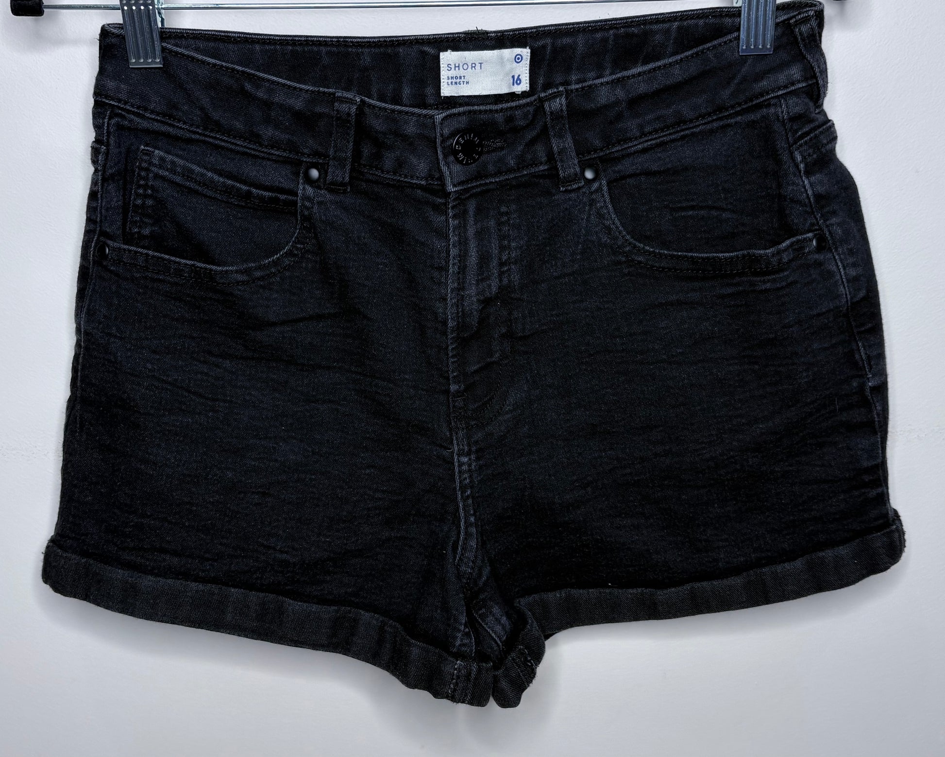 Black denim shorts on a white background