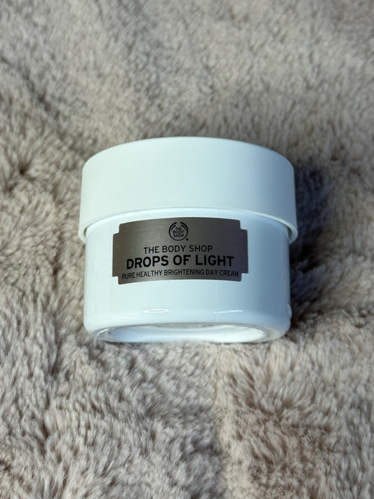Cosmetic jar labeled 'Drops of Light' from The Body Shop 