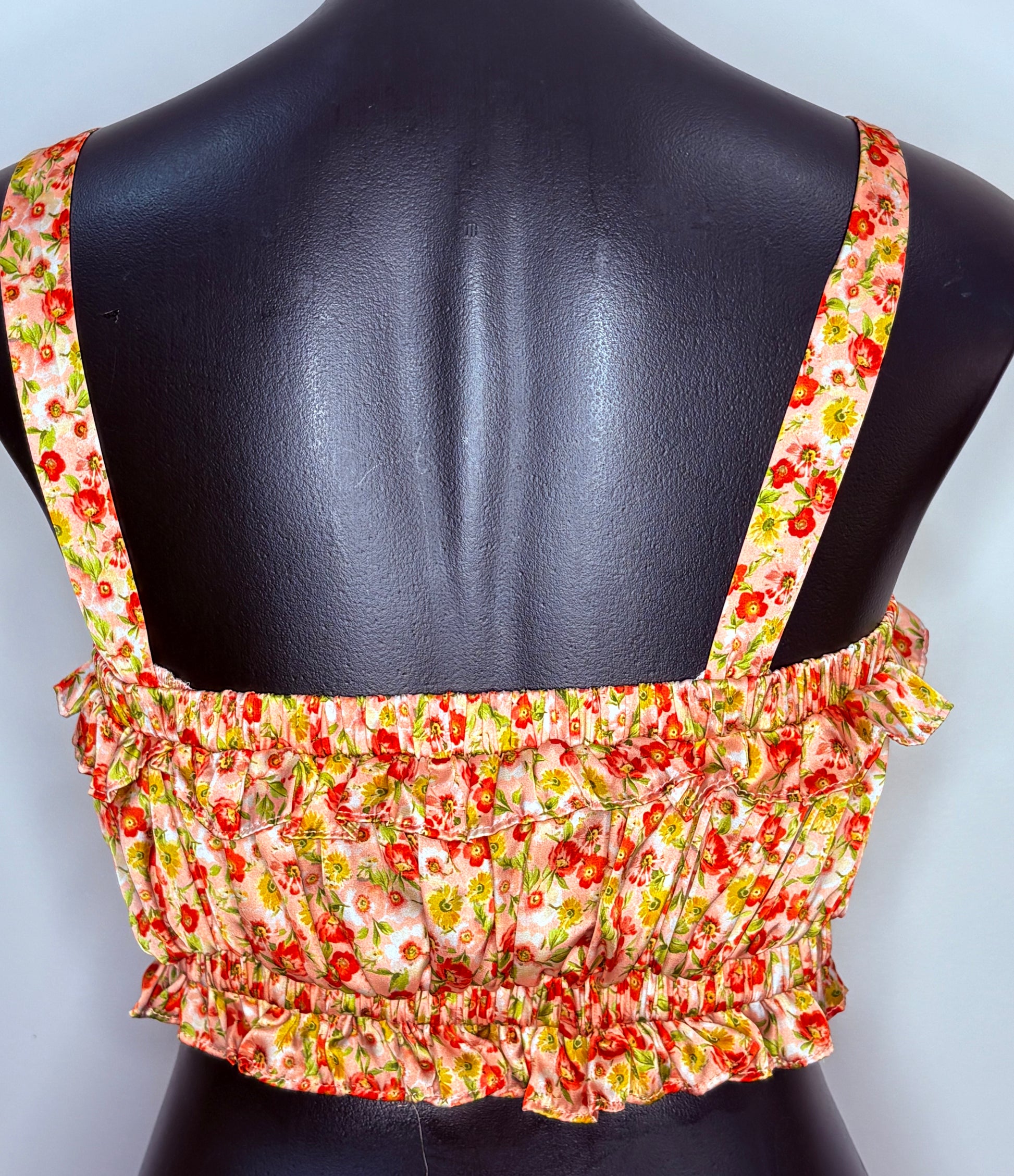 Floral patterned top on a mannequin with a plain background