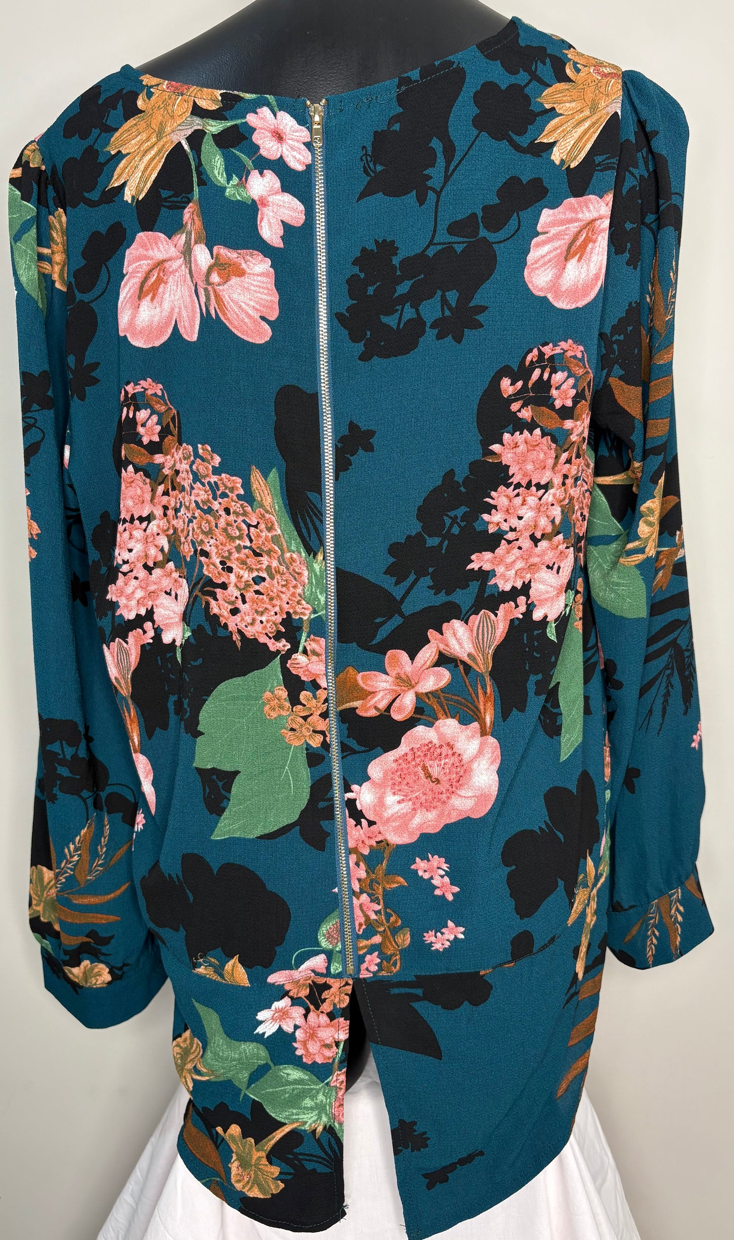 Floral patterned jacket on a mannequin against a white background