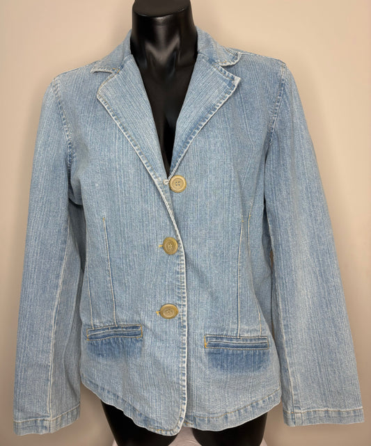 Denim jacket on a mannequin against a beige background