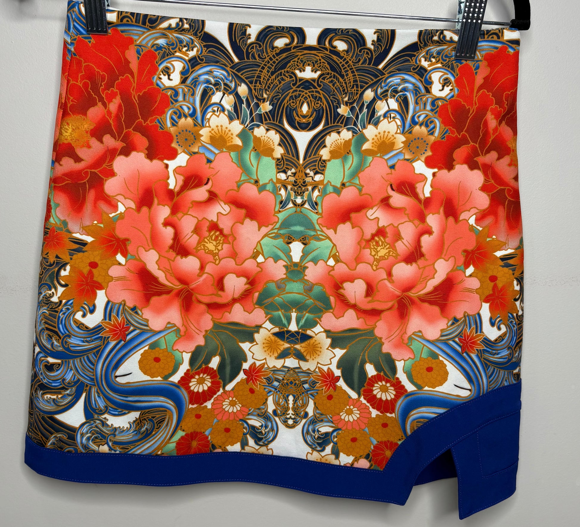 Skirt with a colorful floral and abstract pattern on a plain background