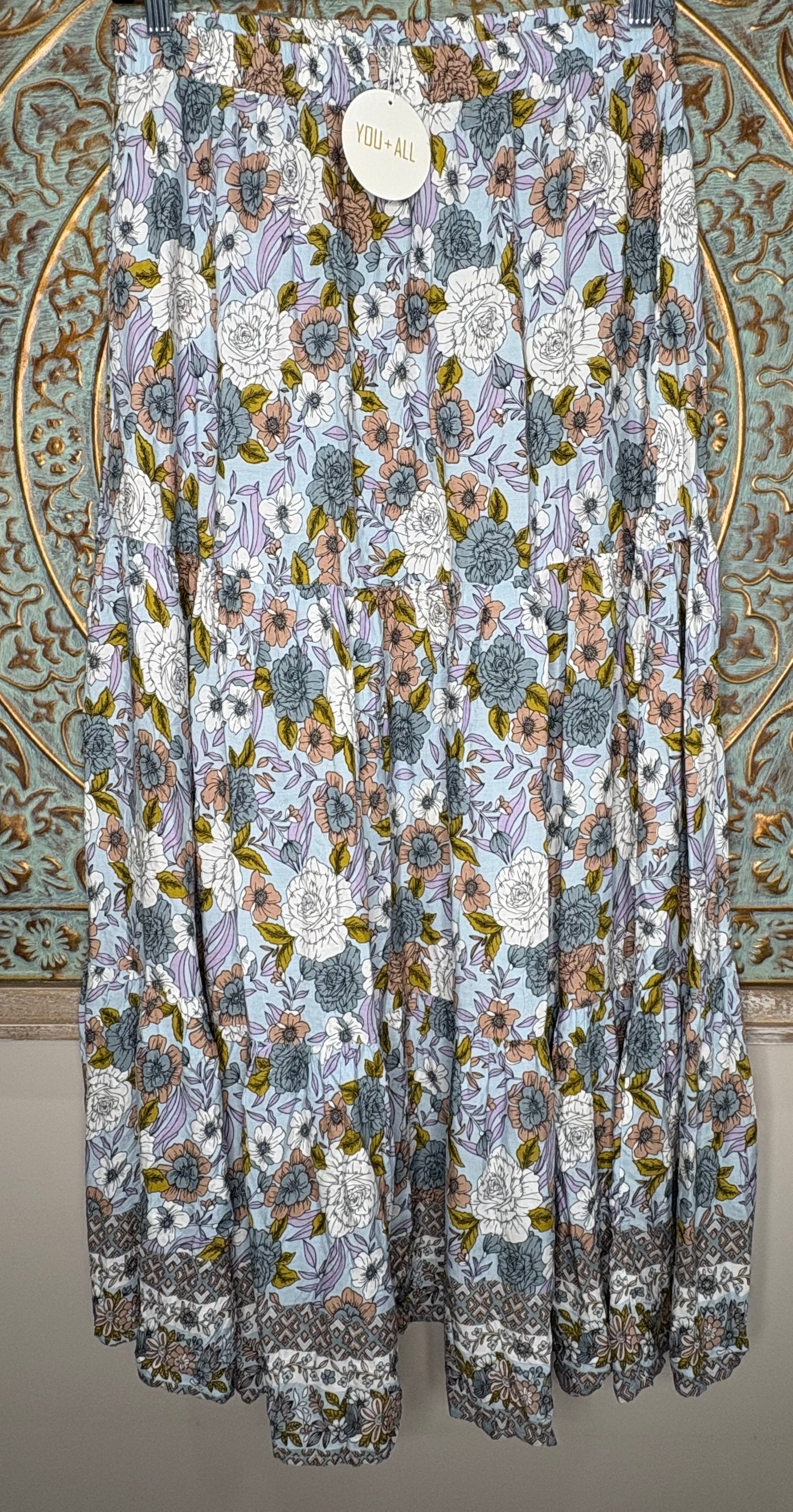 Floral patterned fabric draped over a decorative background