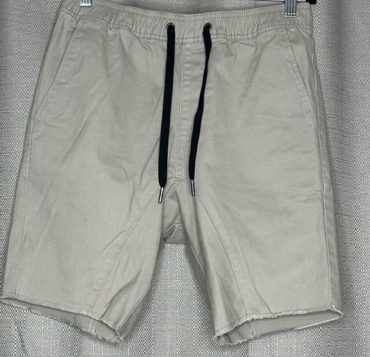 Light Beige shorts with black drawstring waist.